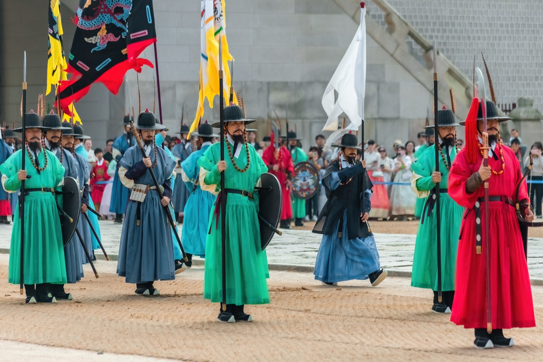 Royal guards in green, blue and red Joseon-era uniforms during the changing ceremony at Gyeongbokgung.